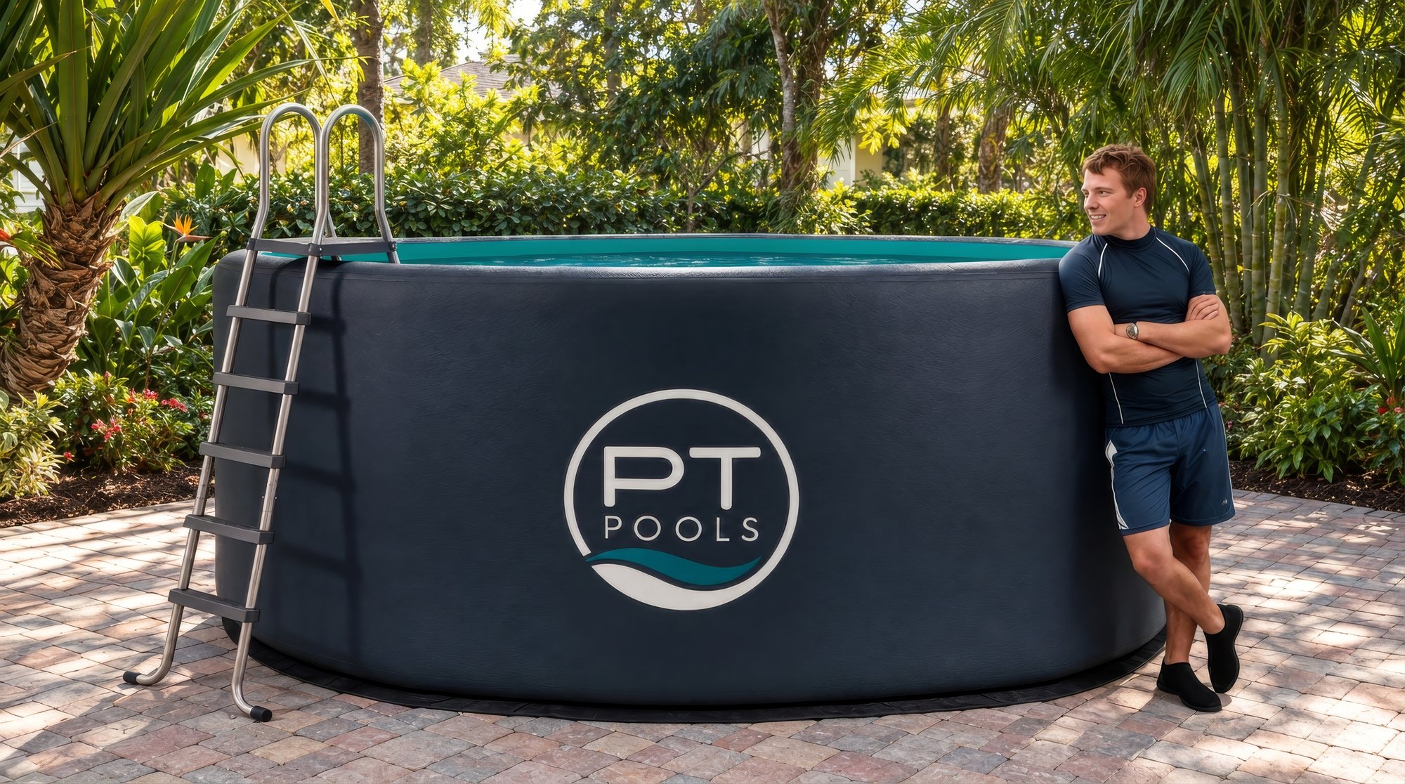 TheraTank in a tropical backyard on a brick paver patio, with a man in a navy rash guard leaning against the pool wall, which comes up to his shoulders.